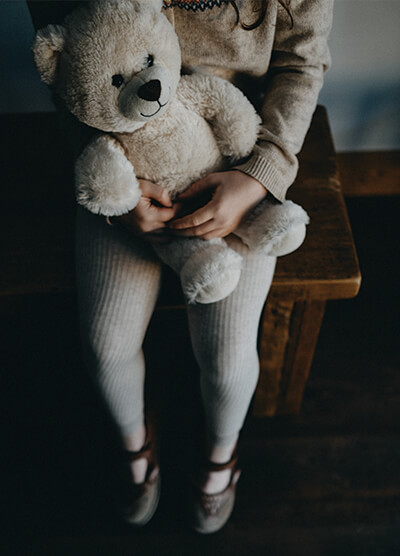 child holding a teddy bear