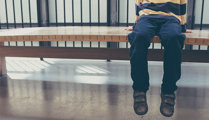 child sitting on bench