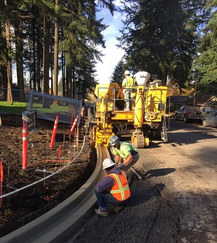 Workers install concrete curbing, November 2016.