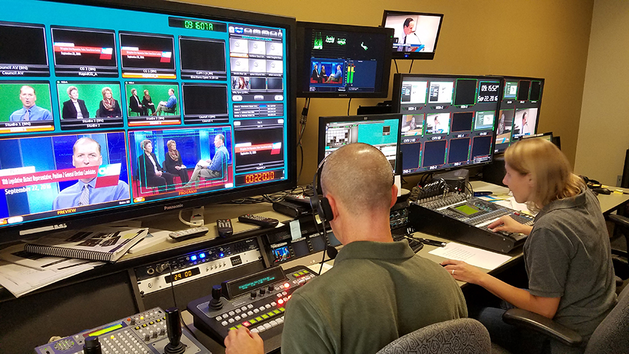 CVTV control room with male and female producers working at control panel