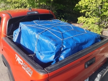 Red truck with a secured load