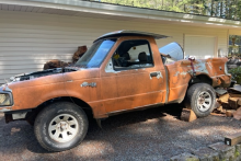 Junk Vehicle.  Truck on wooden blocks with no engine.